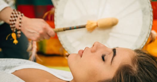 The drum passing over a client during a journey session