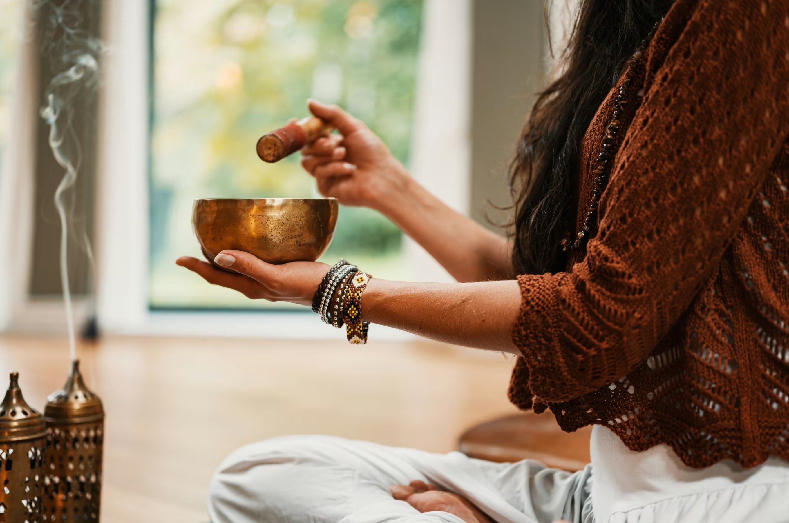 A hand-hammered Tibetan singing bowl held in ceremony